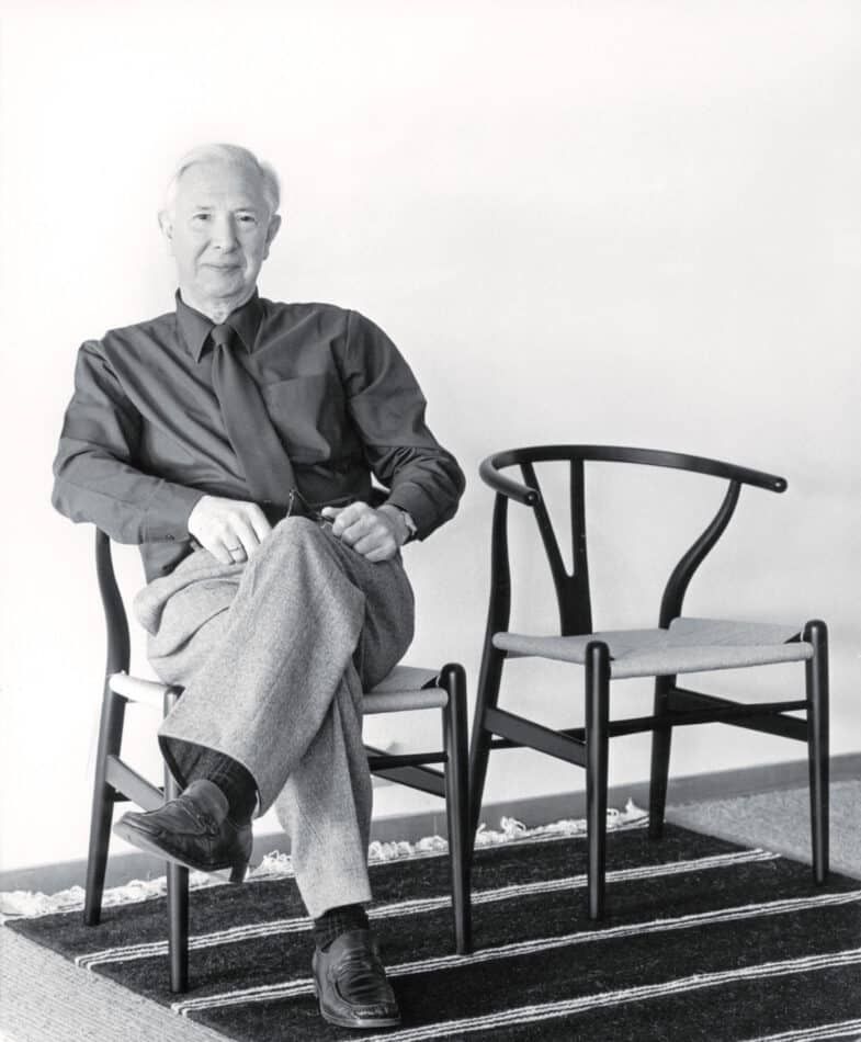 Hans Wegner trying out his chairs