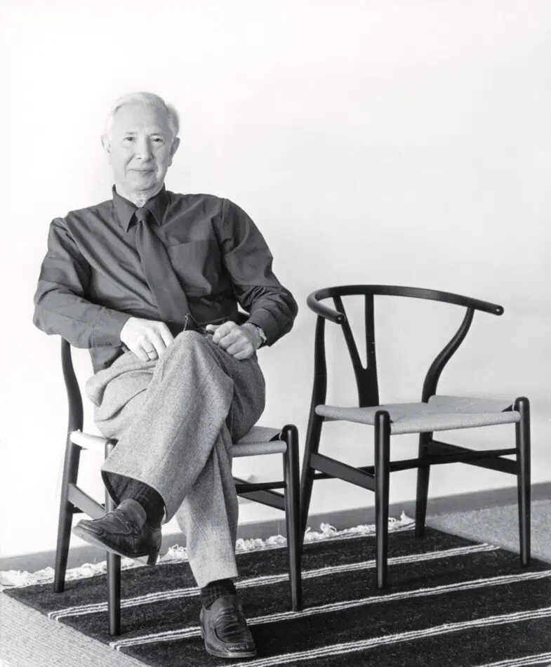 Hans Wegner trying out his Wishbone chairs