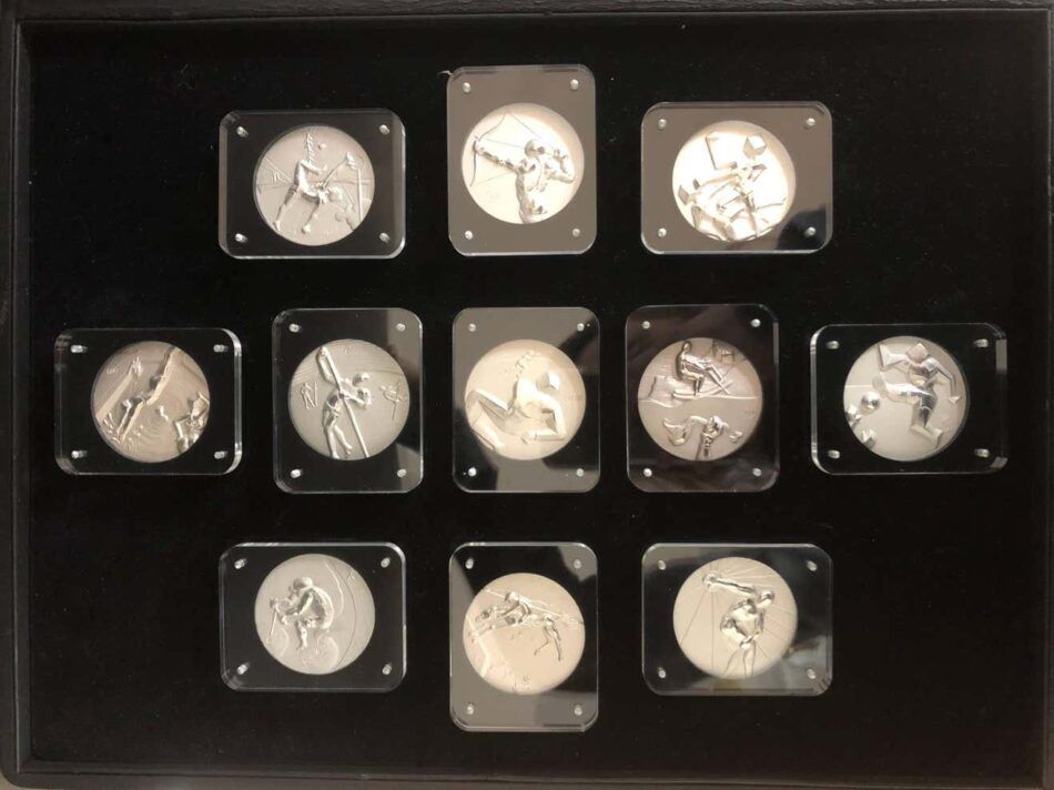 Set of 11 silver Olympic Medallions from 1984 designed by Salvador Dalí depicting different Olympic events