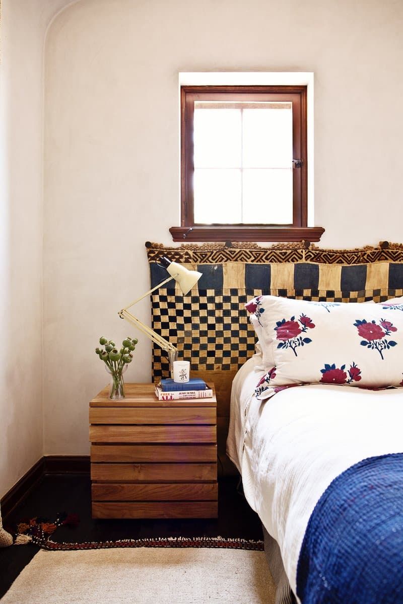 A mud-cloth-style textile serves as a headboard in a Los Angeles bedroom decorated by Reath Design.