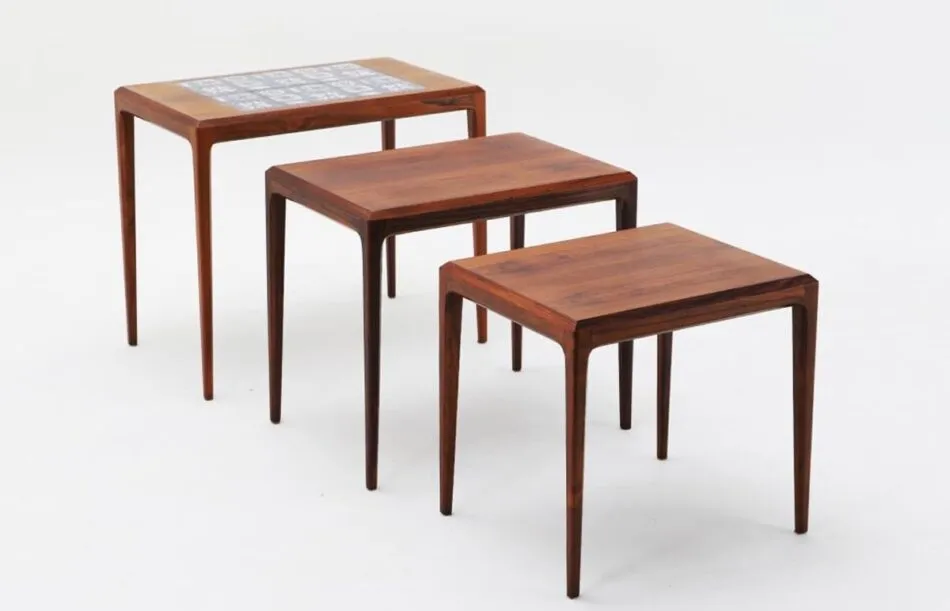  A set of three wooden Johannes Andersen nesting tables stands in descending size order. 
