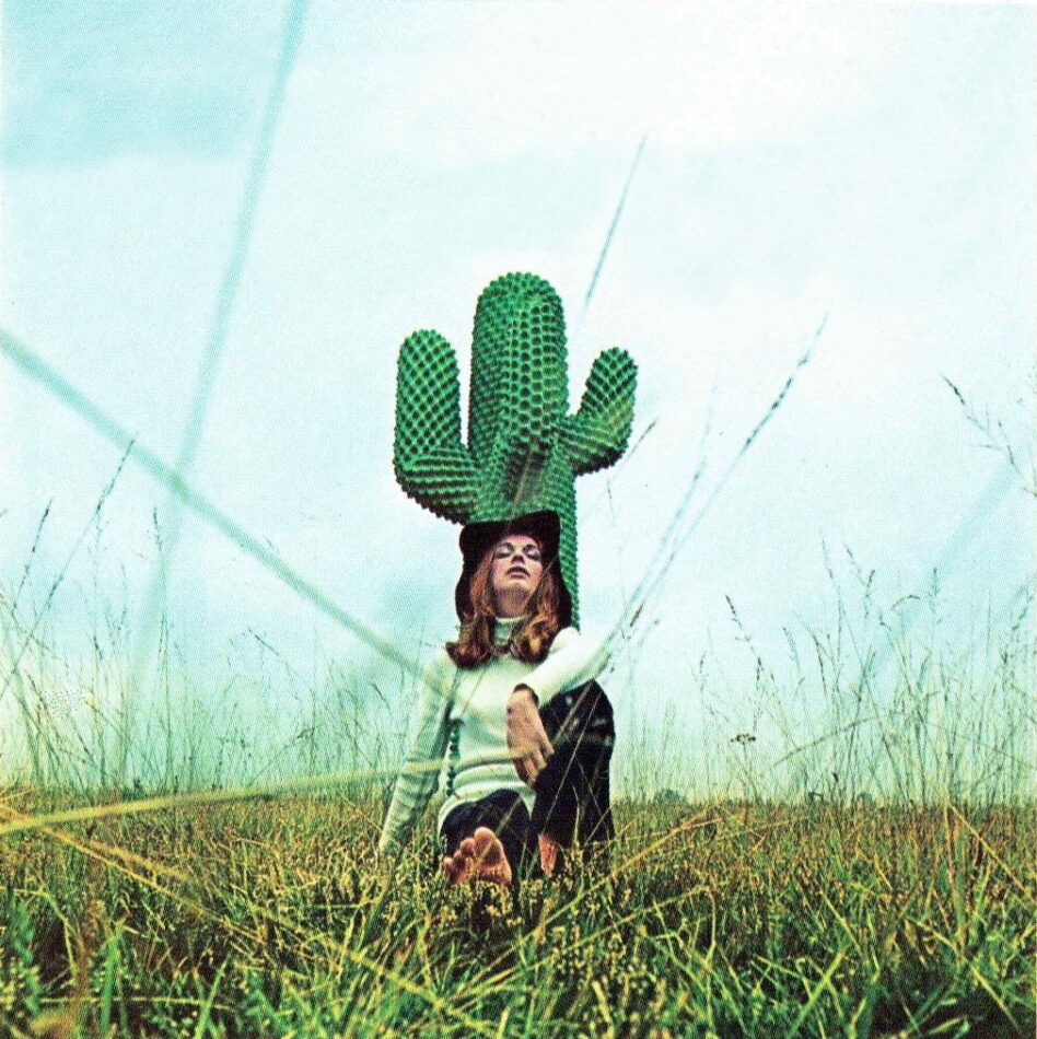 An archival photo of a woman in a field reclining against a full-size Gufram CACTUS