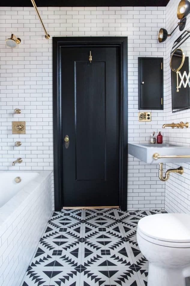 In this Oakland, California, bathroom by Katie Martinez, brass hardware pops against the black and white color scheme.