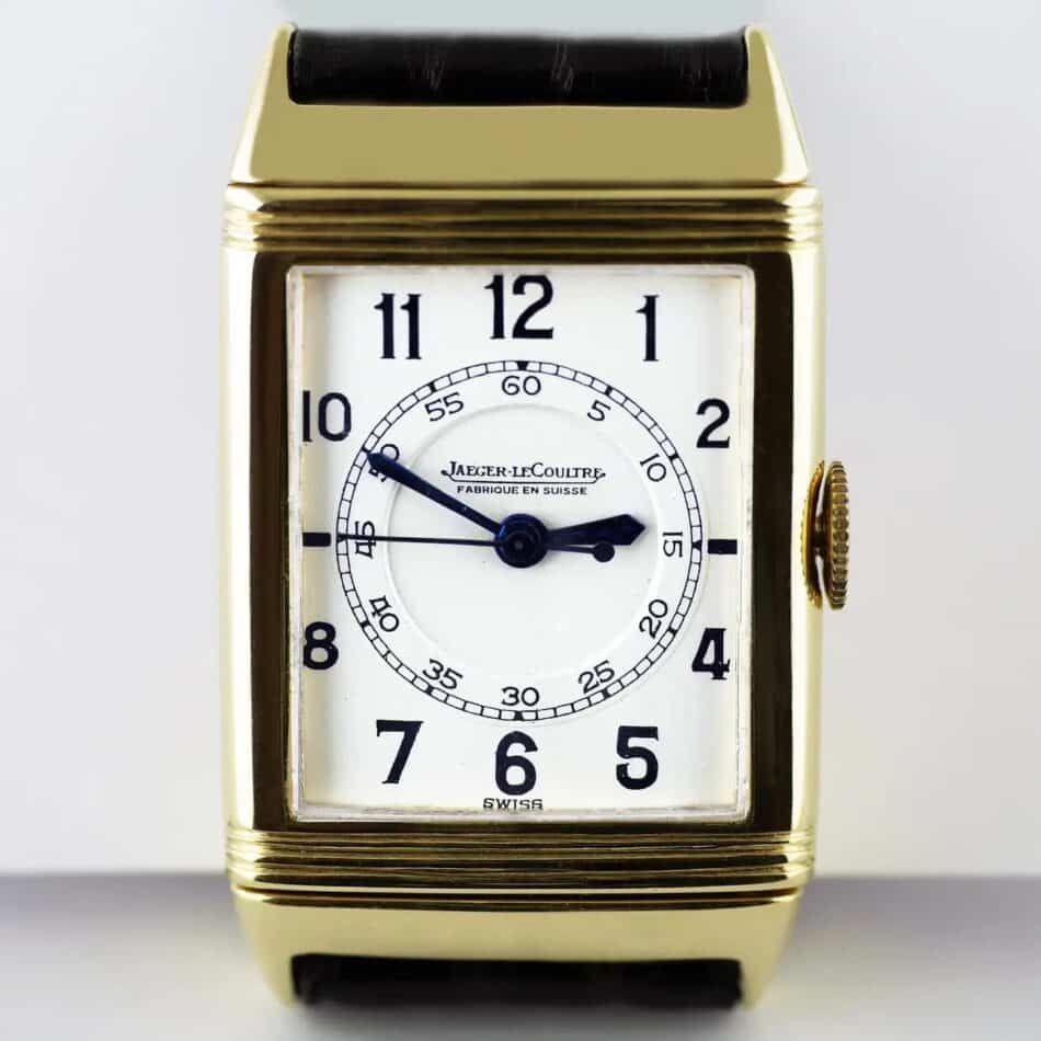 The face of a gold Jaeger-LeCoultre Reverso with Arabic numerals and blued-steel hands