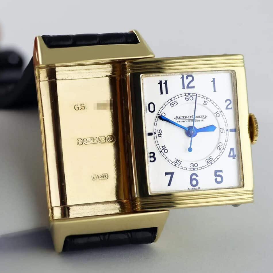 A gold Jaeger-LeCoultre Reverso with the case slid partially out of its cradle