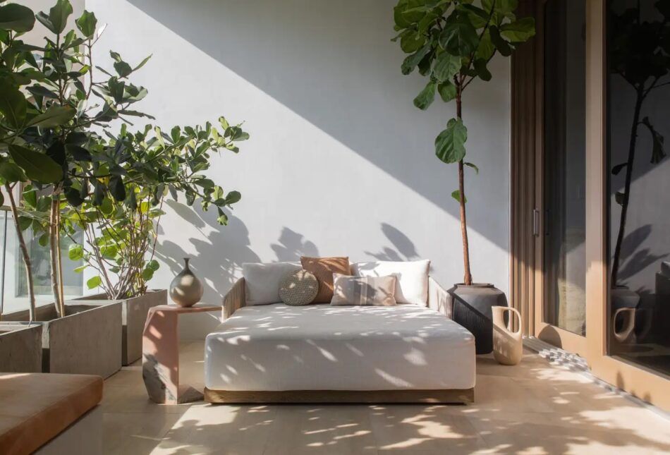 In Miami's celebrated Louver House, an enclosed patio bedecked in calming neutrals by Studio Santos serves as a personal escape for a young executive
