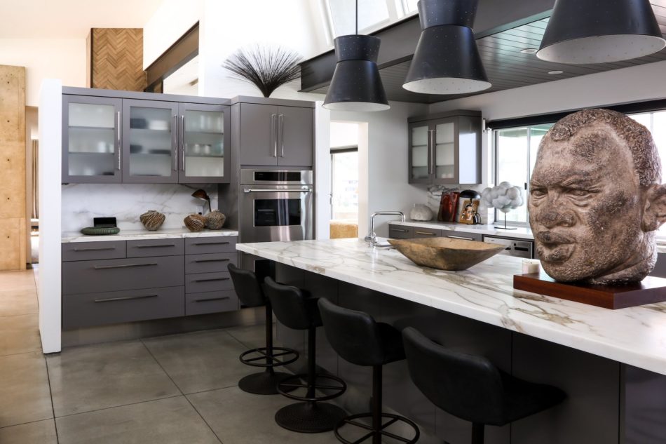 A sculpture of Paul Robeson offsets the clean lines of this Laguna Beach, California, kitchen by Cliff Fong.