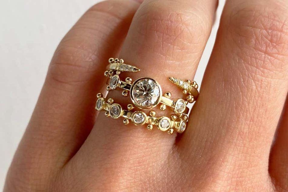 M. Hisae's open stacking ring, white diamond Trinity engagement ring, and Trinity wedding band 
