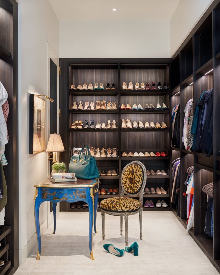 a small closet with albue table and leopard printed chair