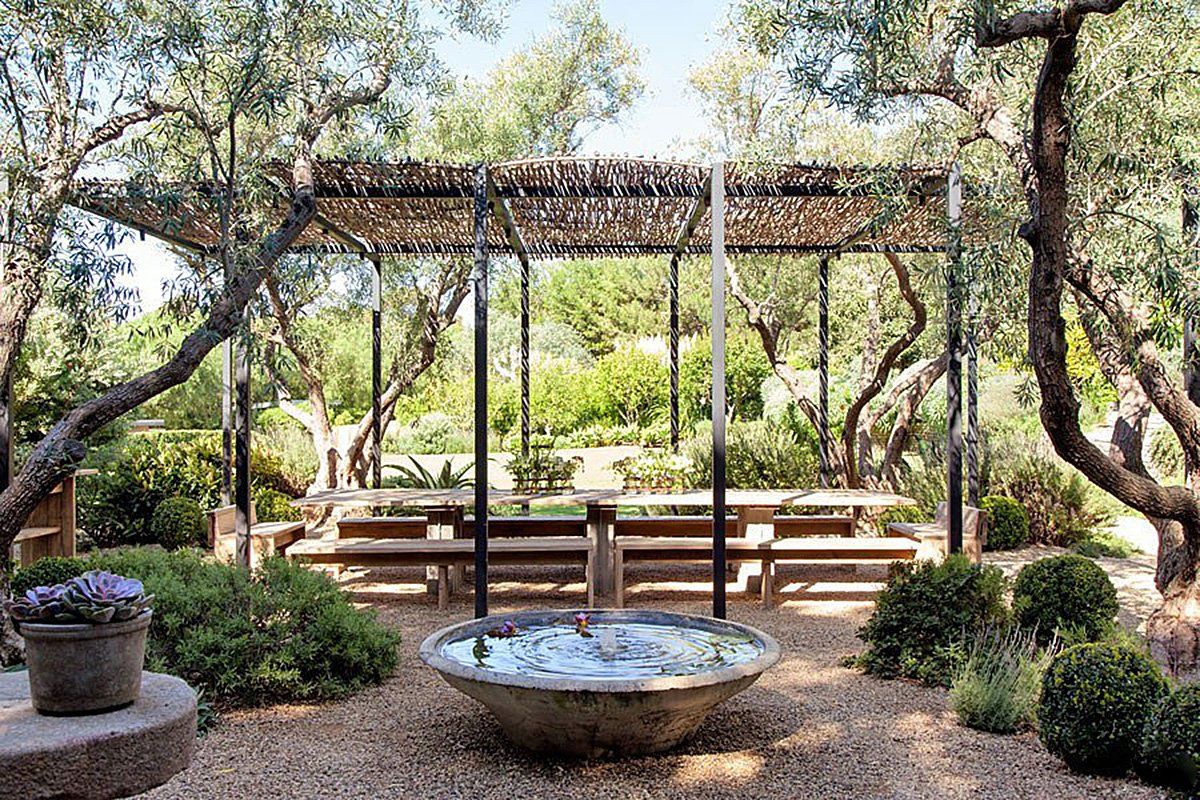 The outdoor dining space of Patrick Dempsey's Malibu family house with revamped interiors by Estee Stanley of Hancock Design.