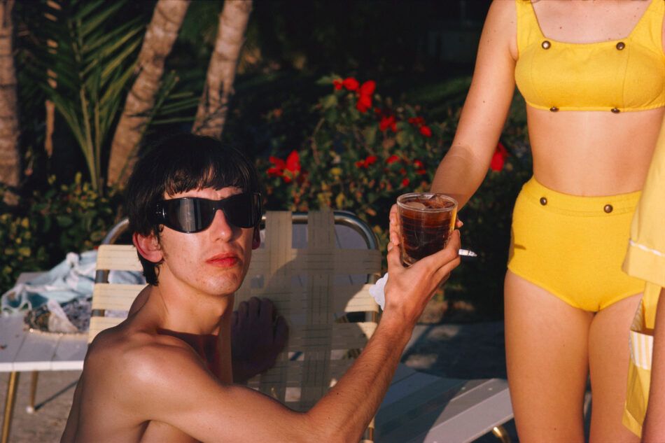 Paul McCartney's photograph of George Harrison and a woman in a yellow bikini in  Miami Beach, February 1964