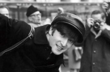 A black-and-white photograph of John Lennon captured by Paul McCartney in Paris in early 1964.