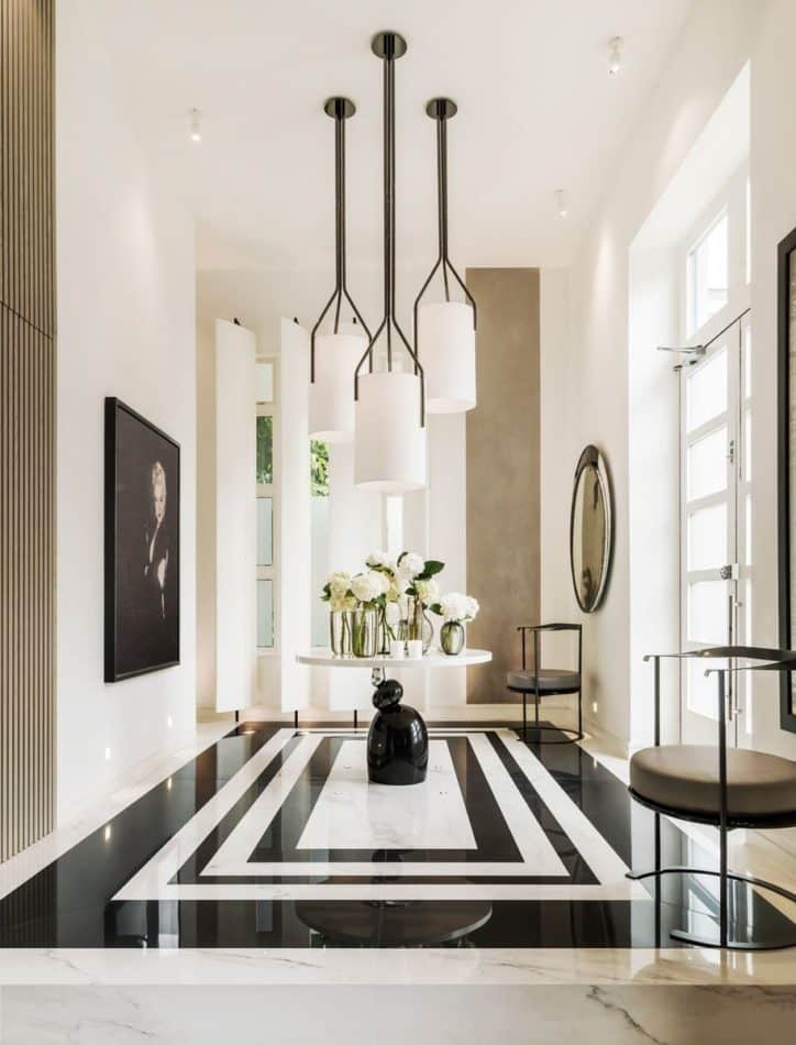 A black and white marble floor sets a dramatic tone in the foyer of Kelly Hoppen’s London home.