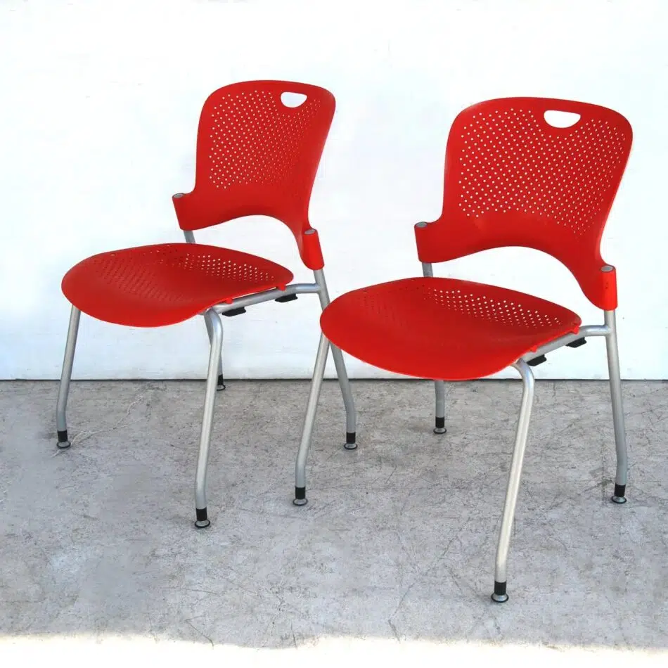 A pair of Jeff Weber for Herman Miller Caper red stacking chairs