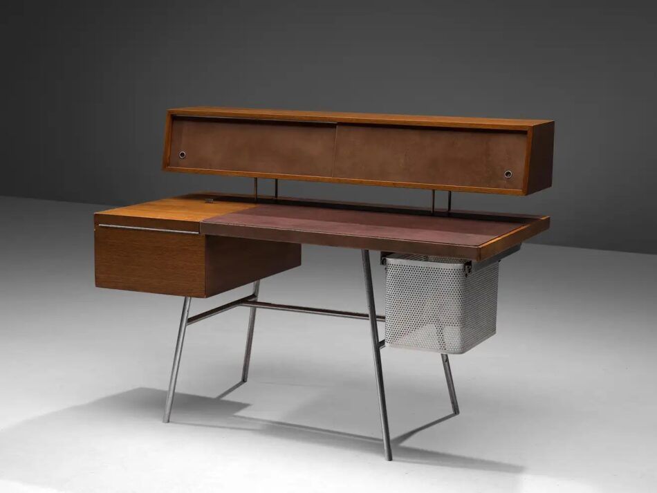 A George Nelson for Herman Miller desk in walnut, with a leather writing surface and steel legs