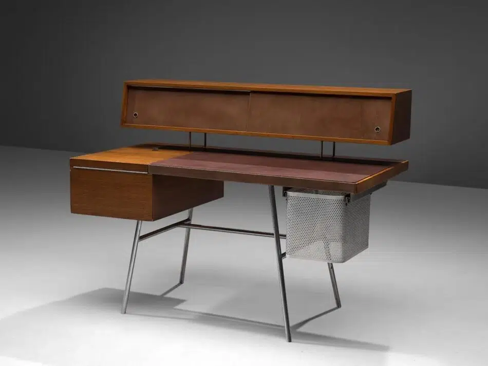 A George Nelson for Herman Miller desk in walnut, with a leather writing surface and steel legs