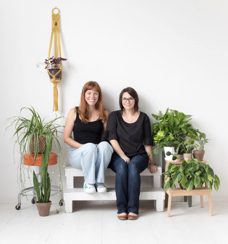 Morgan Doane and Erin Harding among a variety of potted plants