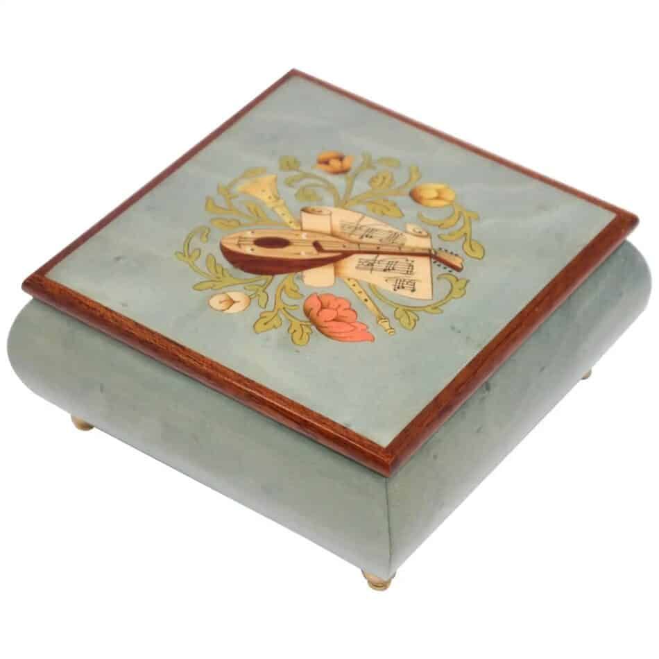 Blue jewelry music box with flowers and instruments on the top
