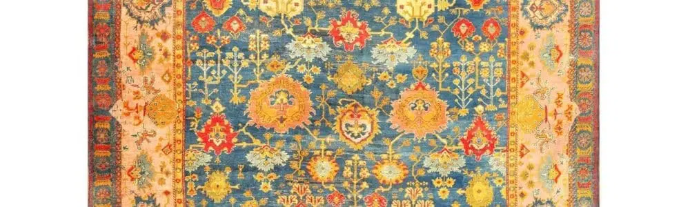 A Turkish Oushak rug featuring rich blues and earth tones
