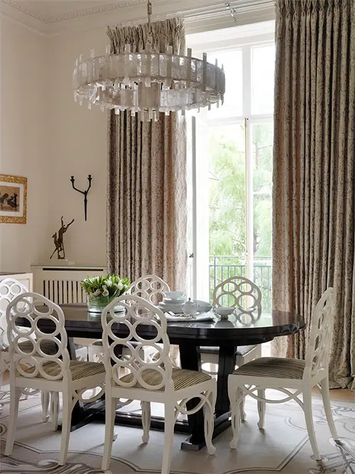 Designer Nina Campbell employed a mostly white palette for the dining room of this London apartment