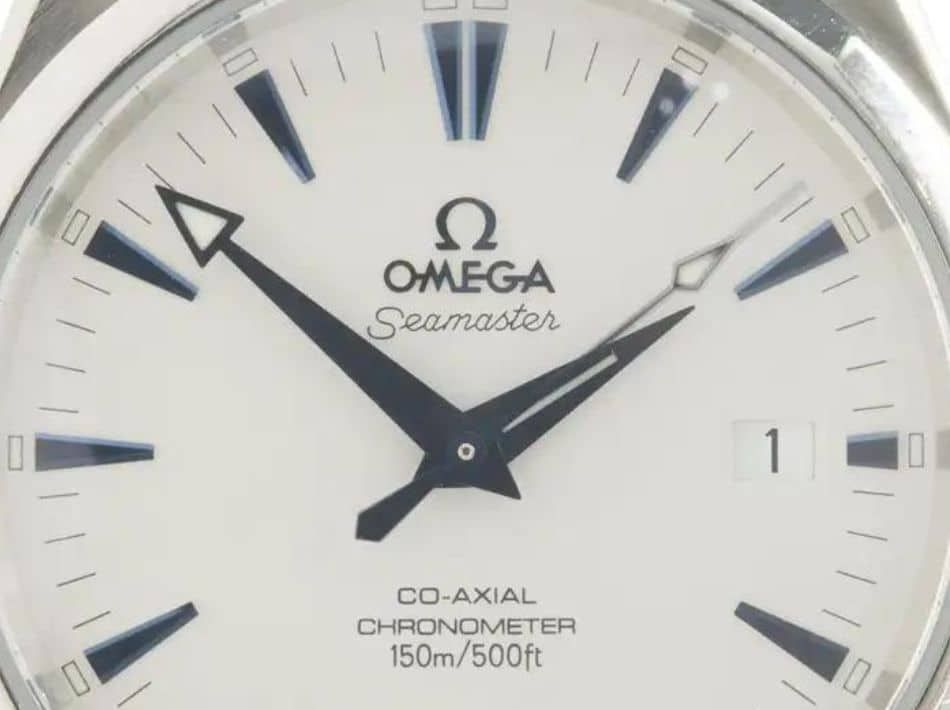 A close-up of the logo on an authentic Omega Seamaster Aqua Terra 150M watch. 