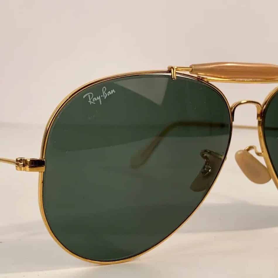 The Ray-Ban signature logo on the right lens of a pair of late-20th-century Outdoorsman sunglasses offered by Opherty & Ciocci