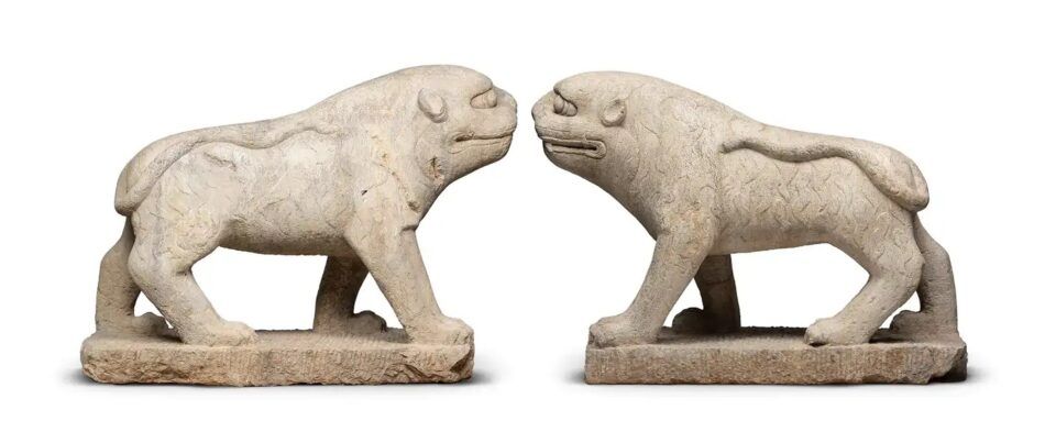 Pair of limestone Qing dynasty tigers facing each other