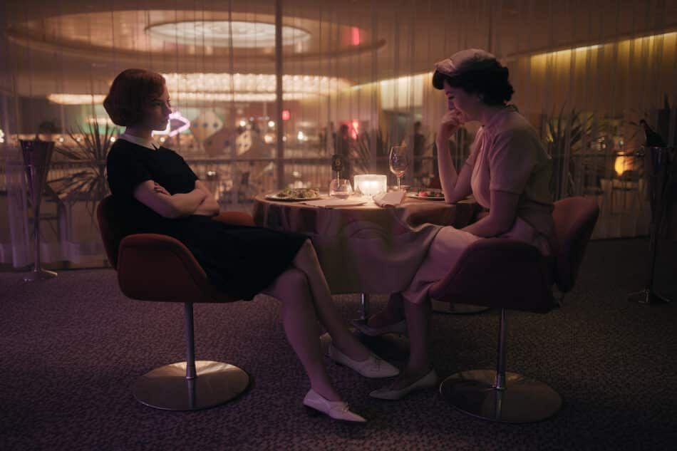Harmon wears a gender-bending Peter Pan collar in in a very 1960s restaurant scene with her mother, Alma Wheatly.