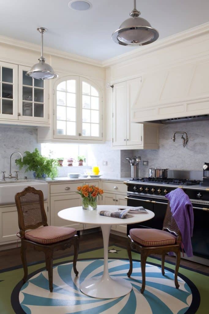 An Eero Saarinen Tulip table stands at the center of the swirl-patterned floor in this Park Avenue kitchen by Brockschmidt & Coleman.
