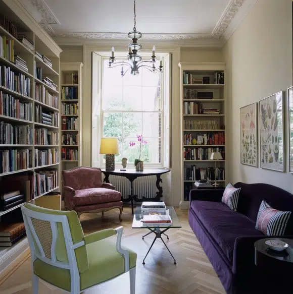 Designer Rita Konig used floor-to-ceiling bookcases and jewel-toned furnishings to make a cozy library nook in this Notting Hill townhouse