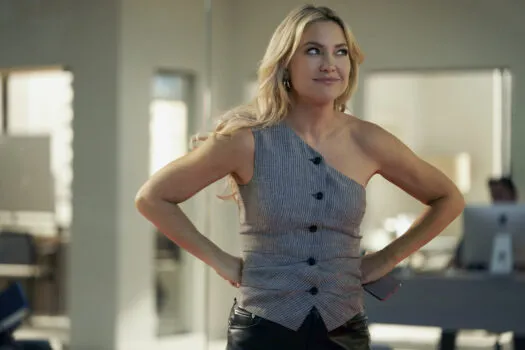 Kate Hudson wearing a one-shouldered sleeveless vest on Running Point.