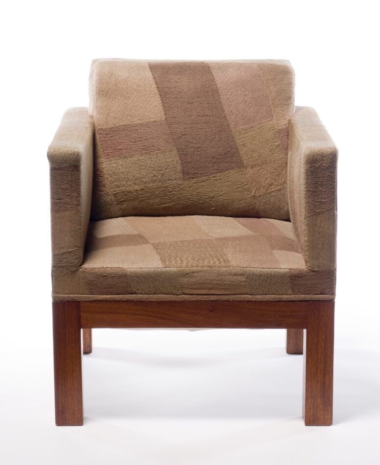 A ca. 1923 chair with tan patchwork upholstery designed by Sonia Delaunay