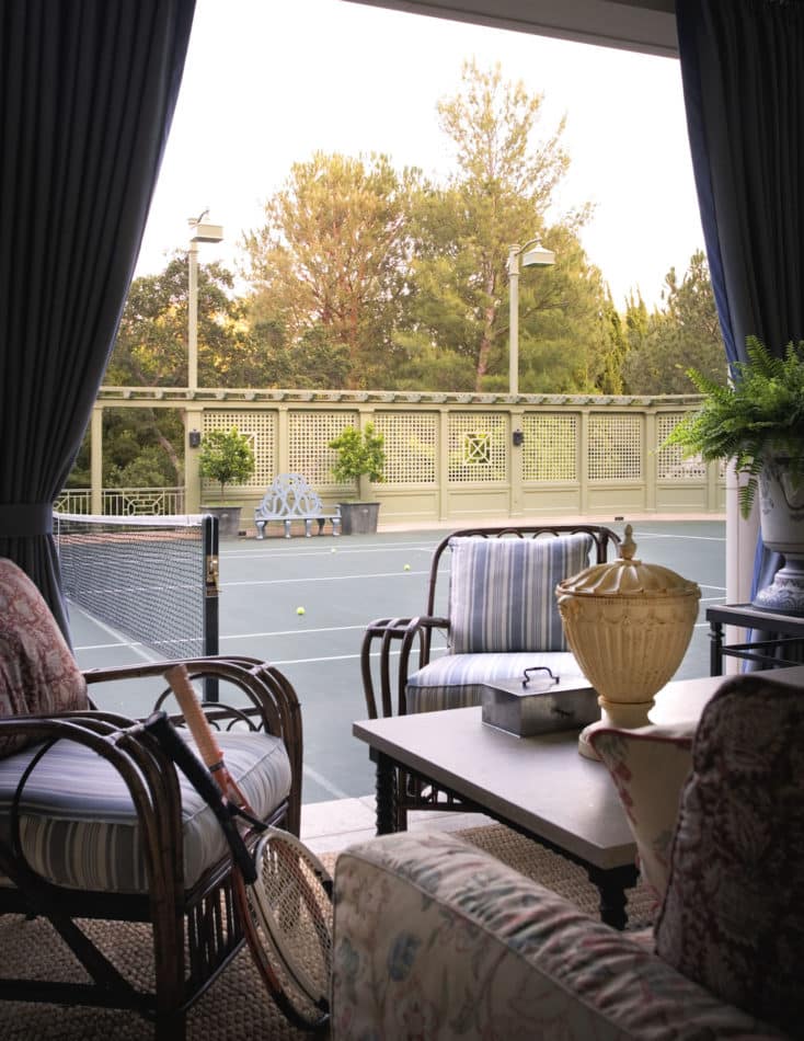 Tented seating area on a tennis court in Los Angeles, designed by Michael S. Smith
