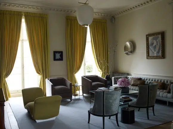 In a London drawing room, designer Steven Volpe placed a Picasso painting above a bespoke tufted sofa