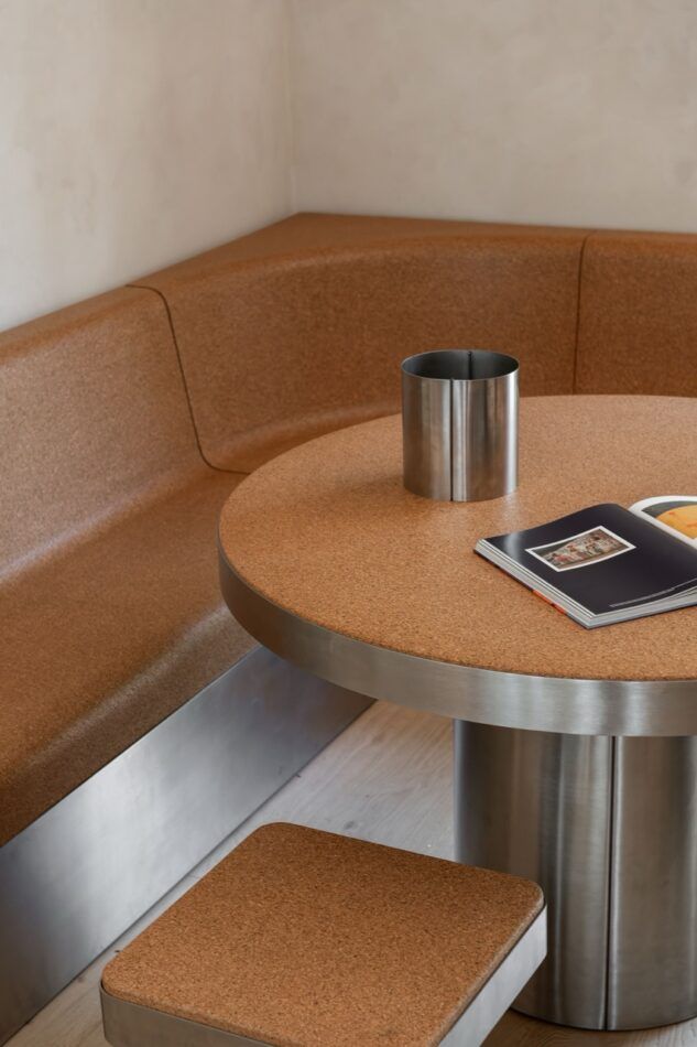 A stool, dining table, and bench made of stainless steel and cork 