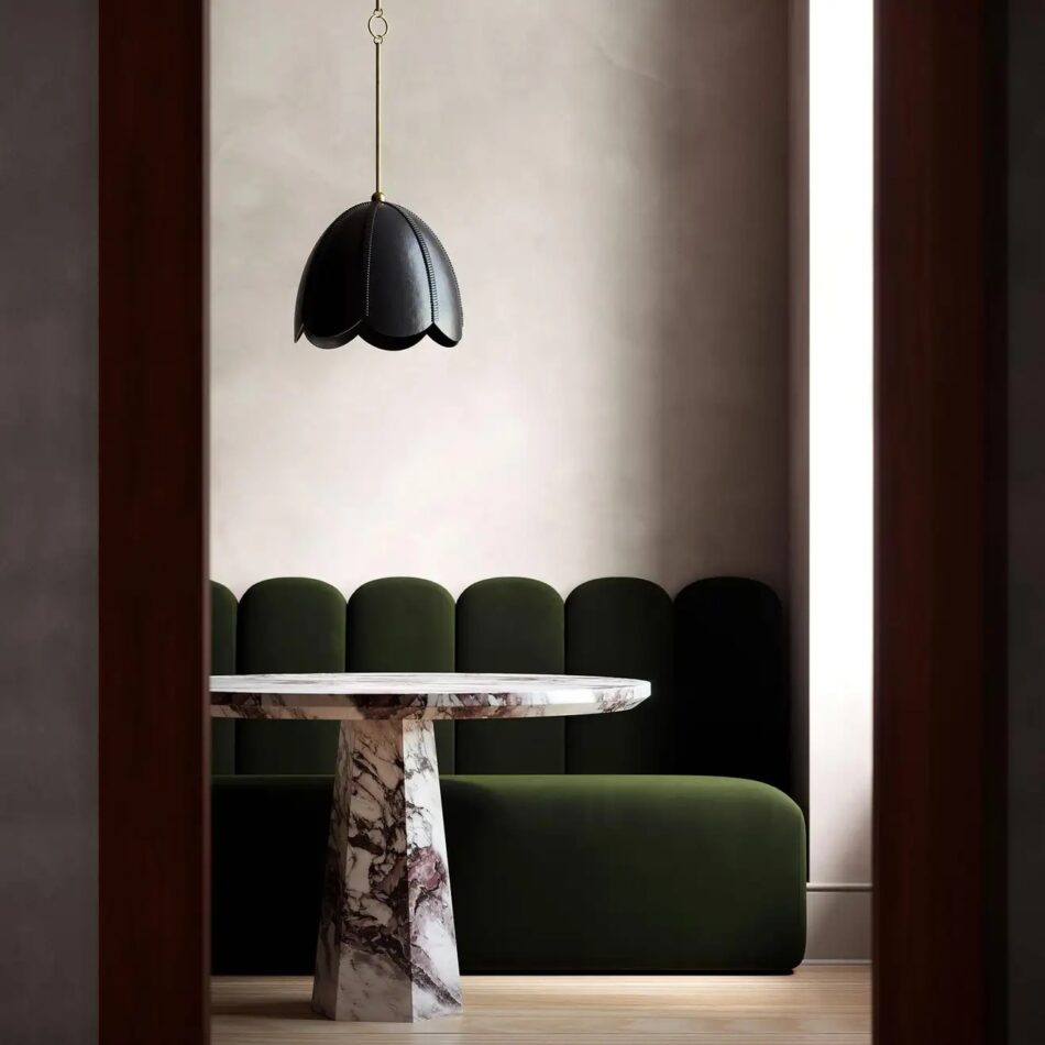 L'Aviva Home Doma leather pendant light in black hanging over a marble table and green velvet banquette