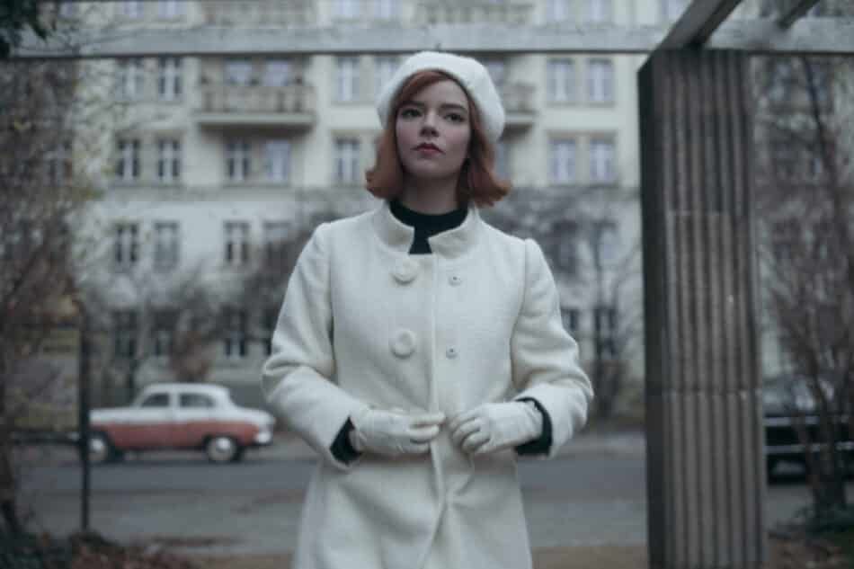 The long white coat and pom-pom beret in this ensemble are intentionally meant to mimic the queen chess piece.