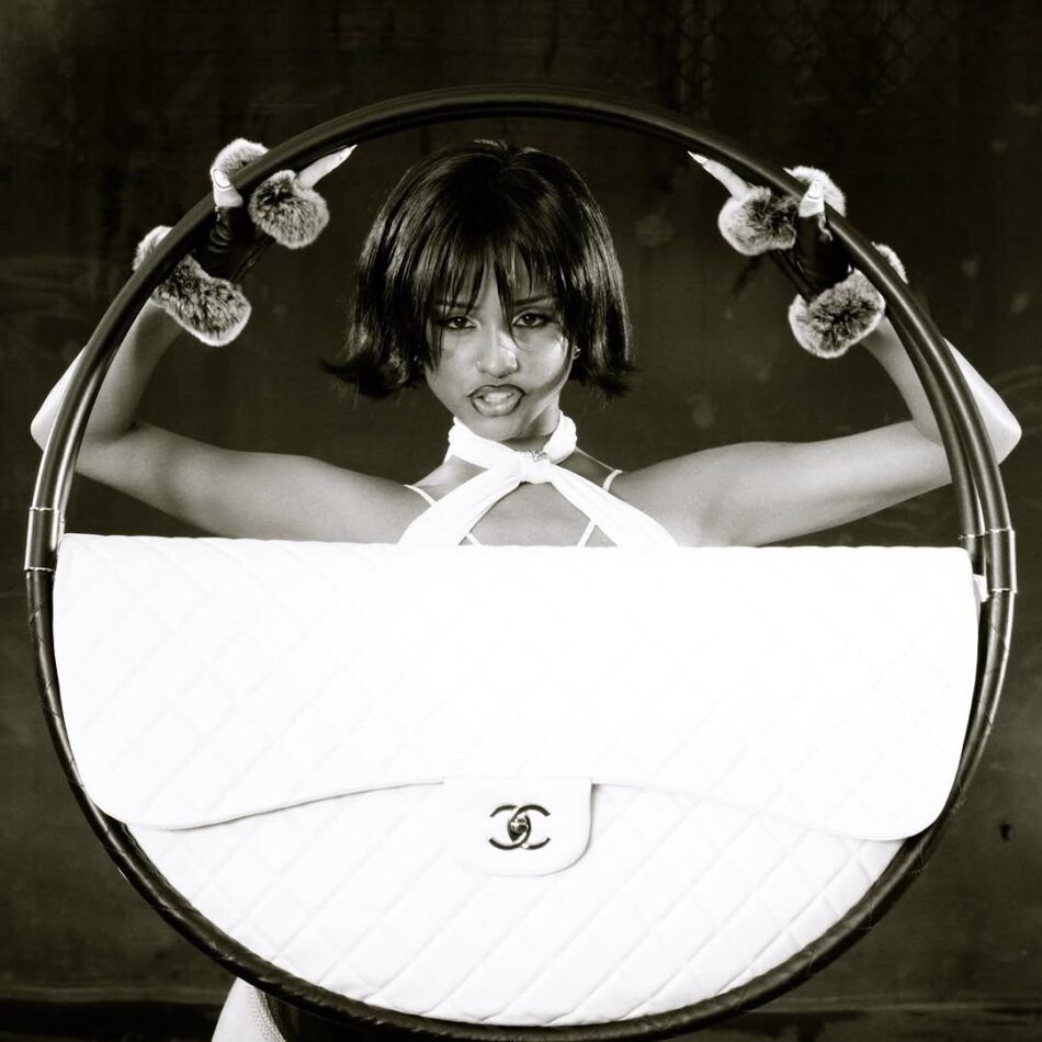 Black and white screengrab from the music video in which Tyla holds a Chanel hula hoop bag