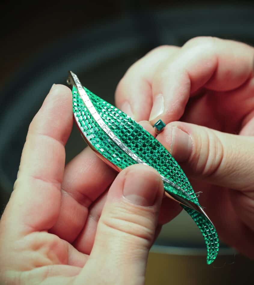 A Van Cleef & Arpels jeweler works on a green Mystery Set leaf