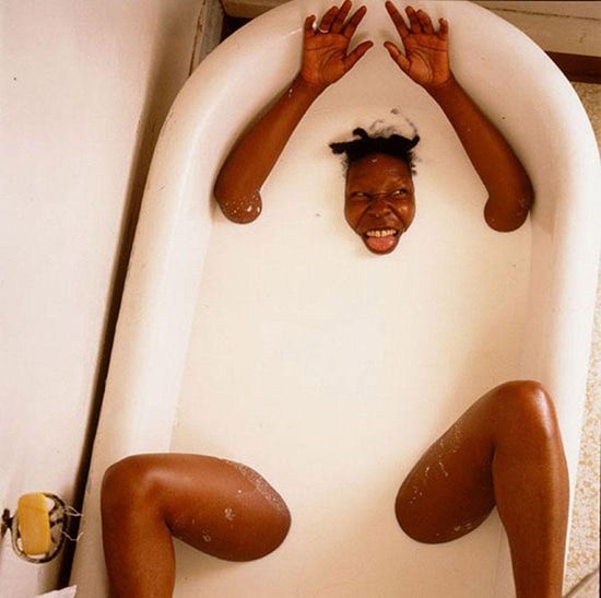 Photograph of Whoopi Goldberg in a bathtub of milk by Annie Leibovitz.