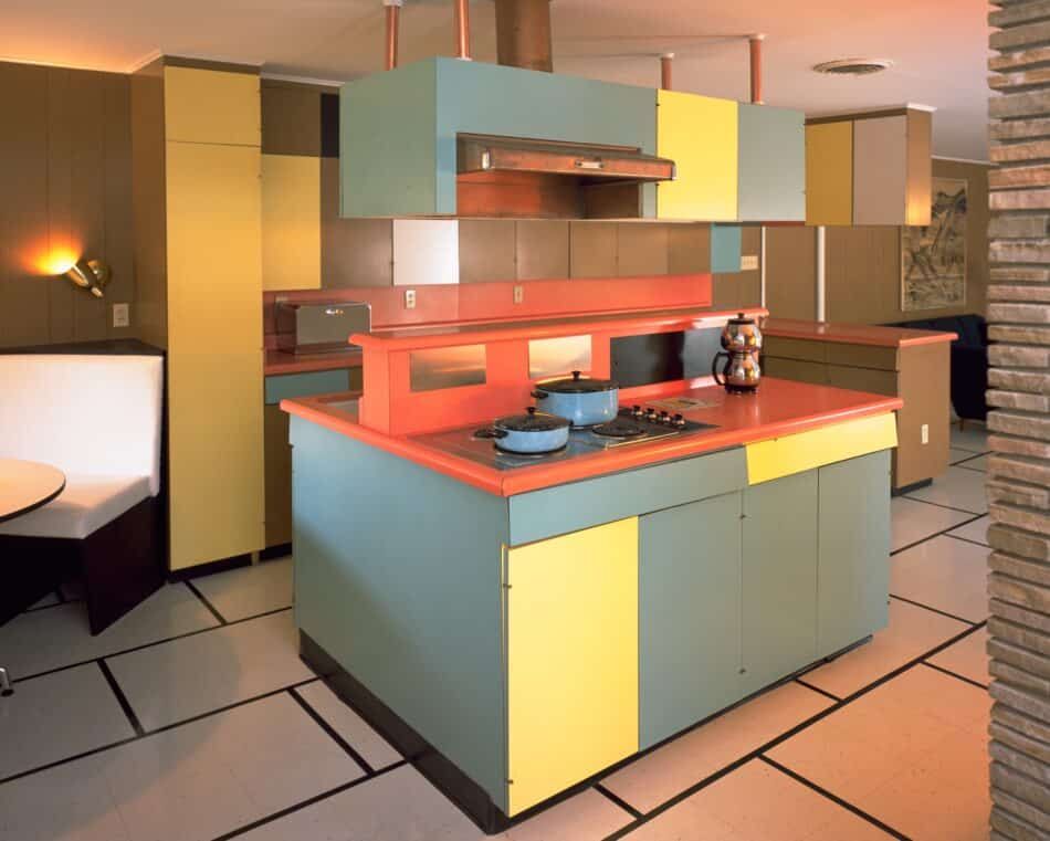 Color-blocked laminated cabinets and countertops fill the kitchen of the Historic Wilson House, in Temple, Texas.