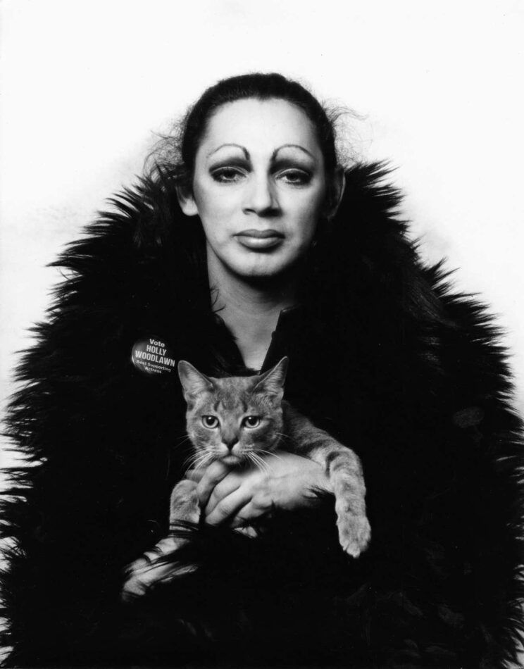 Warhol superstar Holly Woodlawn holding Nik, Mitchell's studio cat, 1971