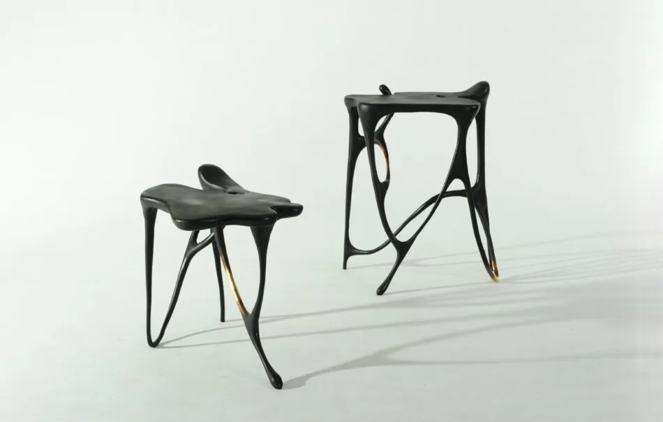 A set of black Misaya end tables with legs in inky designs that mimic the look of calligraphy.