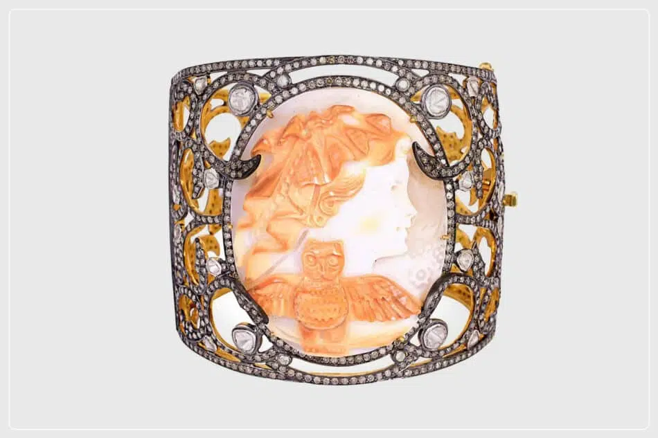 Two examples of contemporary shell cameos include a cuff bracelet in a gold, silver and diamond setting and a carved-skull pendant entwined with a diamond-encrusted, gold snake. 