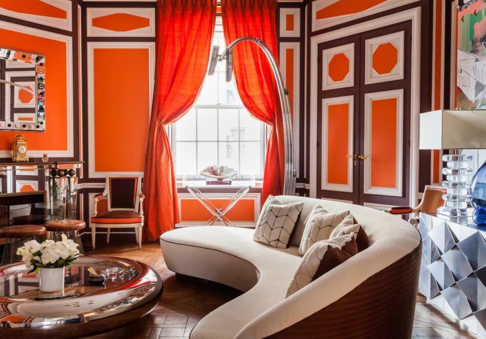 In a spacious Fifth Avenue apartment, designer Robert Couturier played with contrasts across centuries. He says, “We painted the living room’s early-19th-century paneling in late 1960s colors — a foot in both eras!”