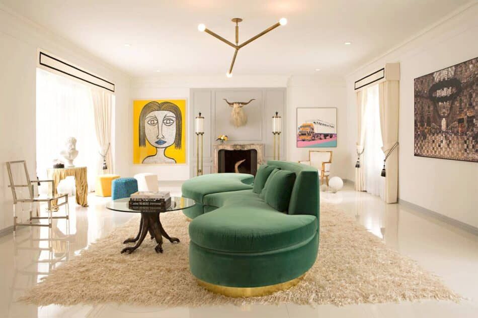 A living room decorated with a serpentine sofa, a white shag rug and contemporary art