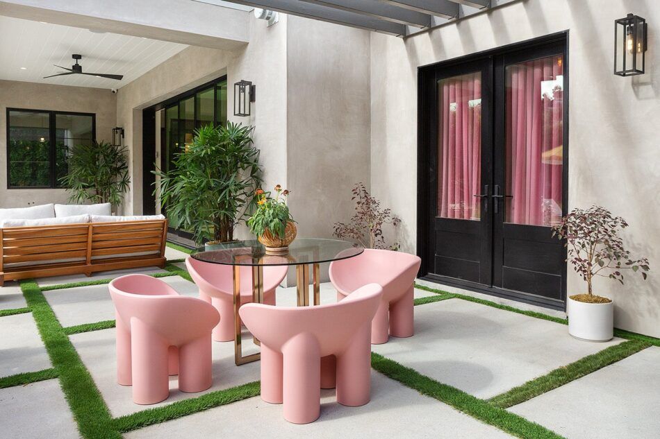 a patio with pink roly poly chairs