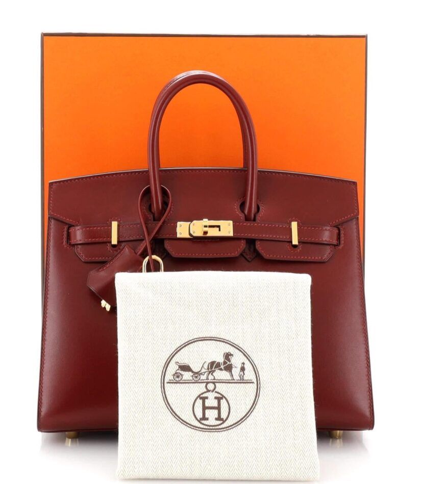 Hermes Birkin bag with orange box and dust bag.