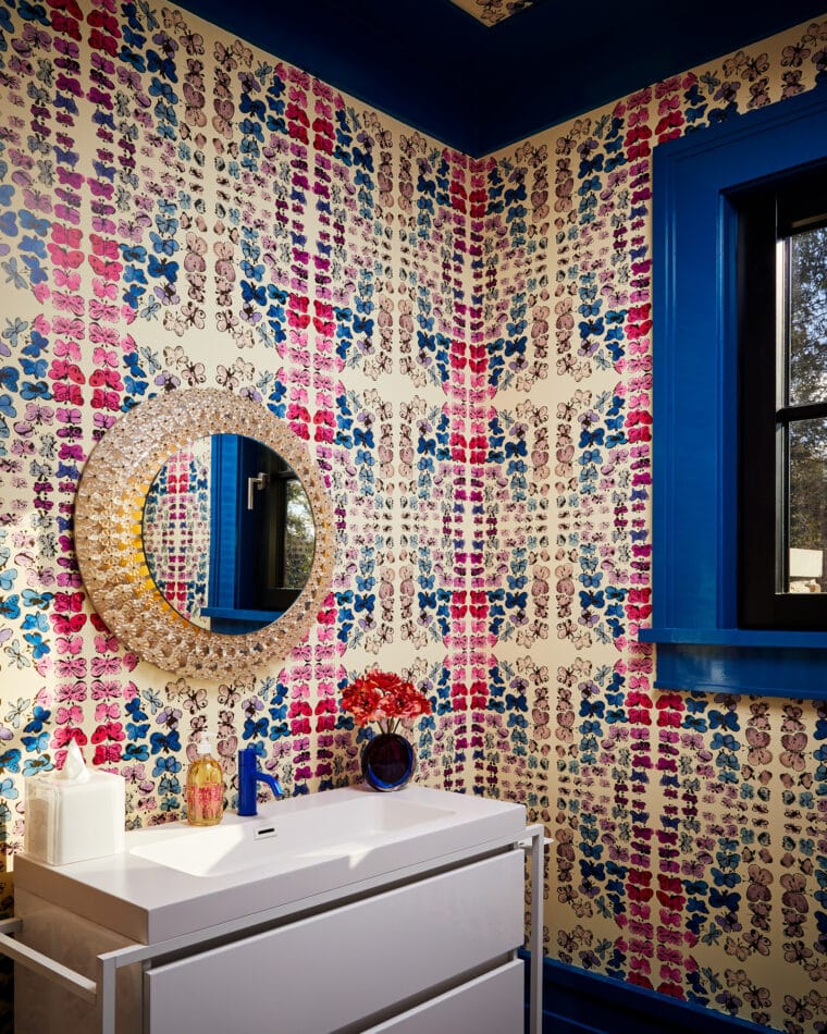 a powder room with a butterfly wallpaper 