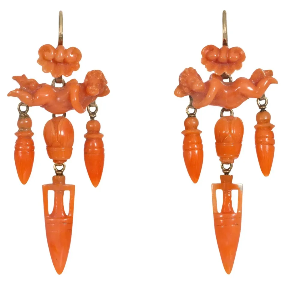 carved coral cupid earrings